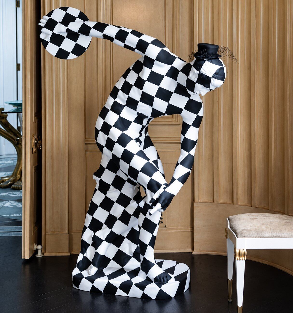 Checkered mime sculpture by Studio Haring